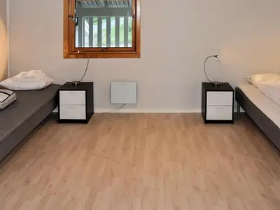 a room with two beds and two night stands at 12 person holiday home in Oksvoll in Oksvoll