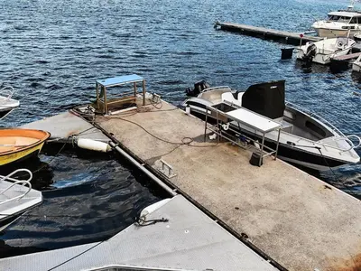 a boat is tied to a dock in the water at 12 person holiday home in Oksvoll in Oksvoll