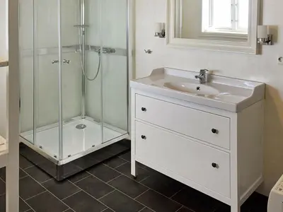 a bathroom with a sink and a shower at 8 person holiday home in averøy in Henda