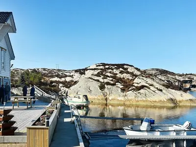 a dock with two boats in a body of water at 8 person holiday home in Urangsvåg in Ervik
