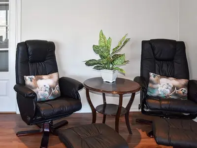 two chairs and a table with a potted plant at 10 person holiday home in Folkestad in Folkestad