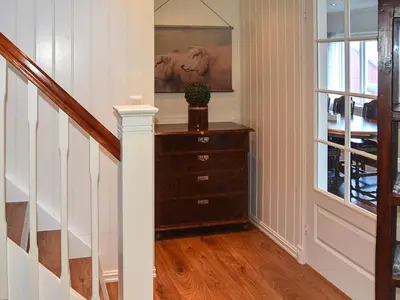 a staircase with a chest of drawers and a window at 10 person holiday home in Folkestad in Folkestad