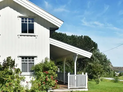 a white house with a fence in front of it at 8 person holiday home in Oksvoll in Oksvoll