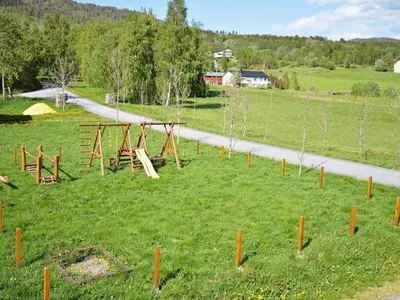 a park with a playground in a field with a road at 10 person holiday home in EIDSVÅG in Rød