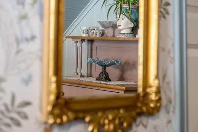 a mirror reflection of a shelf with a vase on it at Villa Solvorn in Solvorn