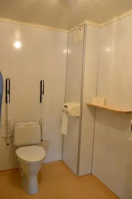 a white bathroom with a toilet and a cabinet at VIKEDAL VERTSHUS hotel in Vikedal