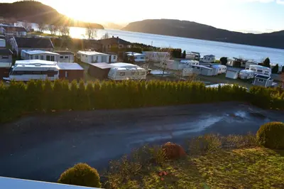 a view of a harbor with a lot of houses and a lake at VIKEDAL VERTSHUS hotel in Vikedal