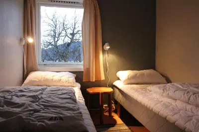 a bedroom with two beds and a window at Åndalsnes Hostel in Åndalsnes