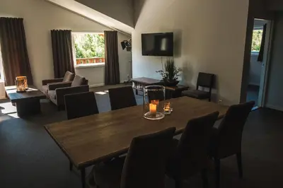 a living room with a table and chairs and a couch at Blåtind Boutique Hotel in Stordal
