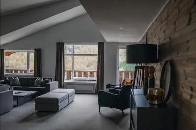 a living room with a couch and a chair at Blåtind Boutique Hotel in Stordal