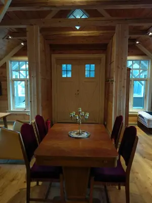 a dining room with a wooden table and chairs at Vikinghaug in Odda