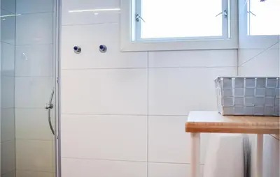 a bathroom with a shower with a glass door at 3 Bedroom Stunning Home In Bjoa in Utbjoa