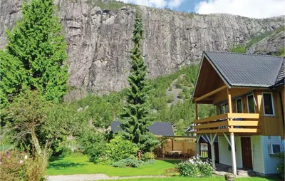 a house with a mountain in the background at 3 Bedroom Lovely Home In Fjæra in Fjæra