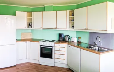 a kitchen with white cabinets and a sink at 2 Bedroom Gorgeous Home In Sveio in Sveio