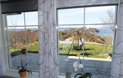 a large window with a view of the water at 2 Bedroom Gorgeous Home In Sveio in Sveio