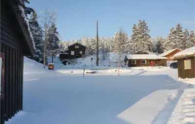a yard covered in snow next to a house at Three-Bedroom Holiday Home In Heidal in Heidal