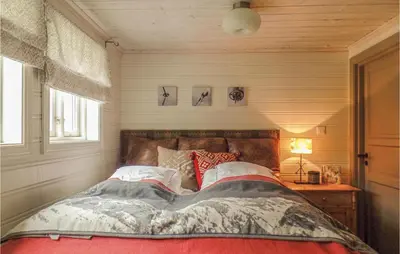 a bed in a room with a window and a bed sidx sidx sidx at Pet Friendly Home In Hovden With Sauna in Hovden