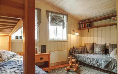 a bedroom with a bed and a couch in a room at Pet Friendly Home In Hovden With Sauna in Hovden