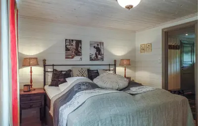 a bedroom with a bed with two pillows on it at Pet Friendly Home In Hovden With Sauna in Hovden