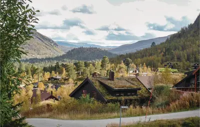 a view of a village with mountains in the background at Nice Home In Hovden With Sauna in Hovden