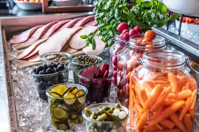 a table with jars of pickles and other vegetables at Scandic Flesland Airport in Bergen