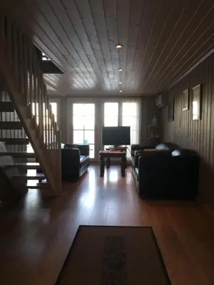 a living room with two couches and a table at Sponavik Camping in Stord