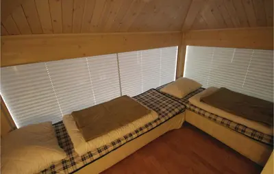 a room with two beds in a room with windows at 3 Bedroom Stunning Home In Sjusjøen in Sjusjøen