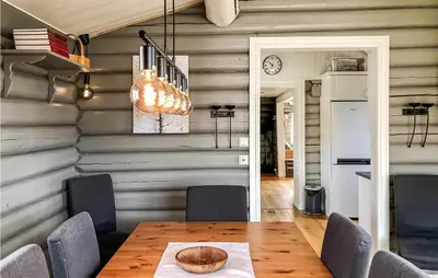 a dining room with a wooden table and chairs at Sjusjøen Setergrend 4730 in Sjusjøen