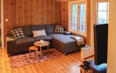 a living room with a couch and a table at Three-Bedroom Holiday Home In Sjusjoen in Sjusjøen