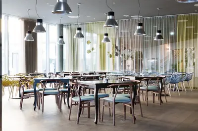 a restaurant with tables and chairs and windows at Comfort Hotel Bergen Airport in Bergen
