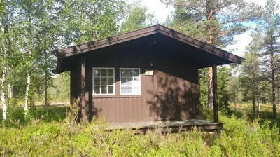 a small cabin in the middle of a field at Sæteråsen Hytter & Camping Trysil in Trysil