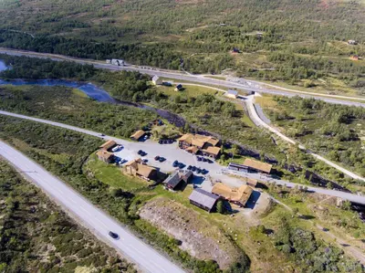 an aerial view of a house next to a road at Dovregubbens Hall in Vålåsjø