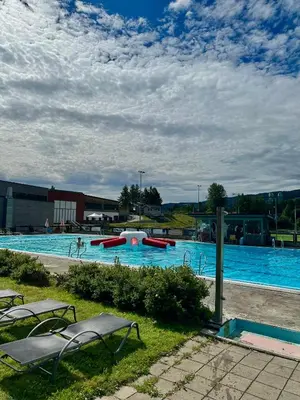 a large swimming pool with slides and chairs in it at Jorekstad Ferieleiligheter in Fåberg