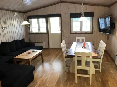 a living room with a table and a couch at Haglebu Turistheim in Haglebu