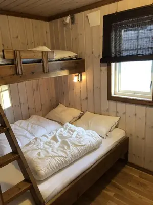 a bedroom with two bunk beds and a window at Haglebu Turistheim in Haglebu