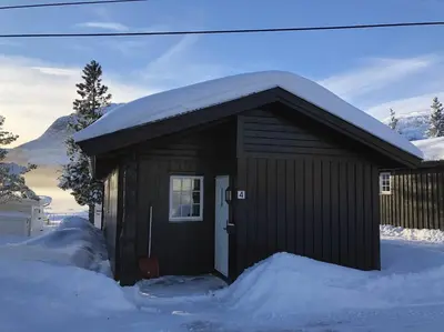 a brown shed with snow on top of it at Haglebu Turistheim in Haglebu