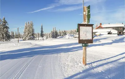 a snow covered street with a sign in the middle at Sjusjøen-Pihl 89 in Sjusjøen