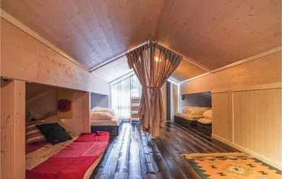 a bedroom with two beds and a drape on the wall at Sjusjøen-Pihl 89 in Sjusjøen