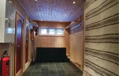 a hallway of a room with wooden walls and a window at Sjusjøen Pihl 4020 in Sjusjøen