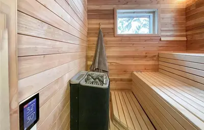 a sauna with a clock in the middle of it at Sjusjøen Pihl 4020 in Sjusjøen
