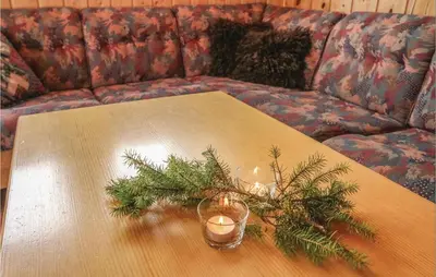 a table with a christmas tree and candles on a couch at Gorgeous Home In Sjusjøen With Sauna in Sjusjøen