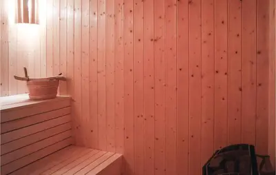 a corner of a room with a wooden wall at Gorgeous Home In Sjusjøen With Sauna in Sjusjøen