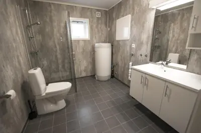 a bathroom with a toilet and a shower and a sink at Lofthus Camping in Lofthus