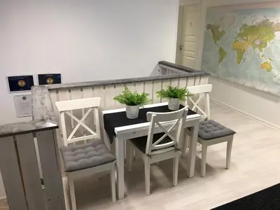 a kitchen with a table and two chairs and a counter at Vinstra Hostel in Vinstra