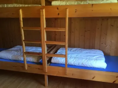 two bunk beds in a wooden room at Jostedal Camping in Jostedal