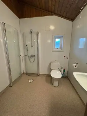 a bathroom with a shower and a toilet and a sink at Skottneset Feriesenter in Barmen
