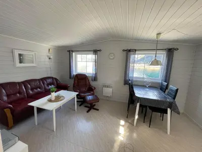 a living room with a couch and a table at Skottneset Feriesenter in Barmen