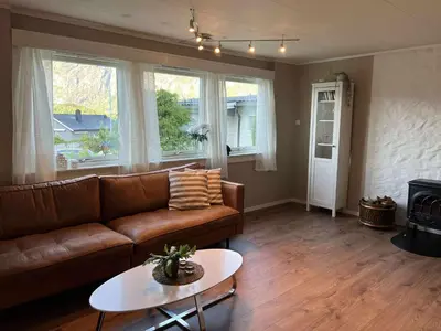 a living room with a couch and a table at Fonnagata in Åndalsnes