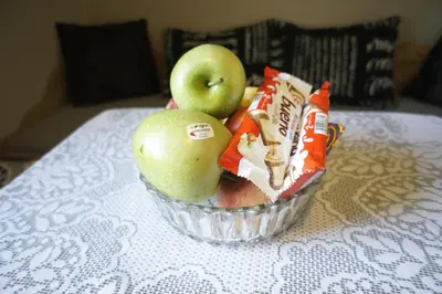 a bowl of apples and a bag of chips on a table at Berge & Laila's Private Apartment in Førde
