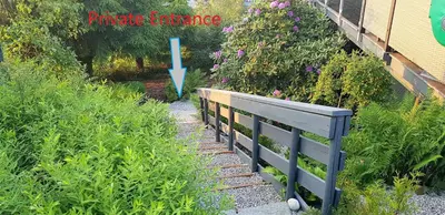 a garden with a wooden fence and flowers at Berge & Laila's Private Apartment in Førde